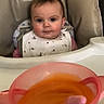 Améliane a rejoint le concours — aidez-le/la à gagner de superbes lots ! baby, bib, bowl, cheeks, child, expression, eyes, face, feeding, food, highchair, home_interior, infant, kitchen, plant, portrait, puree, seat, spoon, tray