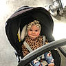 Améliane a rejoint le concours — aidez-le/la à gagner de superbes lots ! accessory, baby, booties, car_seat, child, clothing, cozy, cute, floor, headband, indoor, infant, leopard_print, plush, portrait, rosy_cheeks, seatbelt, smile, stroller, toy