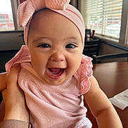 Alaia joined the competition — help win amazing prizes! baby, child, clothing, cute, daylight, expression, face, hand, happy, headwear, indoor, infant, person, pink_headband, portrait, skin, smiling, table, window, young_child