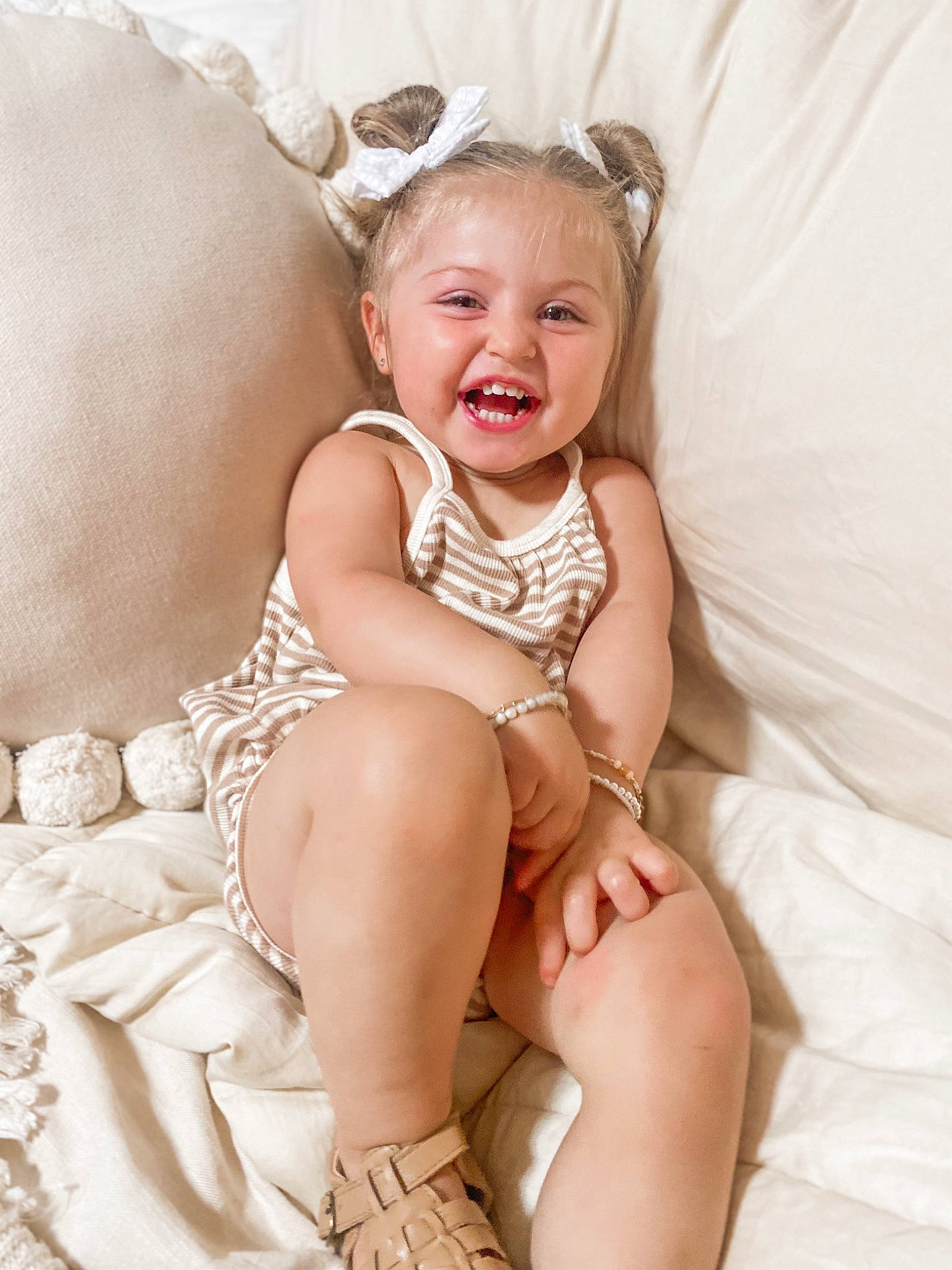 Thea is registered to the contest to win money with this photo: arm, baby, baby_toddler_clothing, comfort, eye, face, finger, hairstyle, happy, head, human_body, iris, neck, person, photograph, pink, skin, smile, stomach, thigh