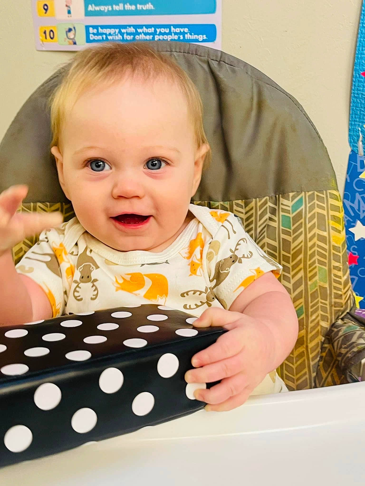 August is registered to the contest to win money with this photo: baby, baby_products, baby_toddler_clothing, blue, chair, cheek, child, curtain, eyelash, flag, happy, human, indoor_games_and_sports, pattern, person, play, room, sitting, sleeve, table