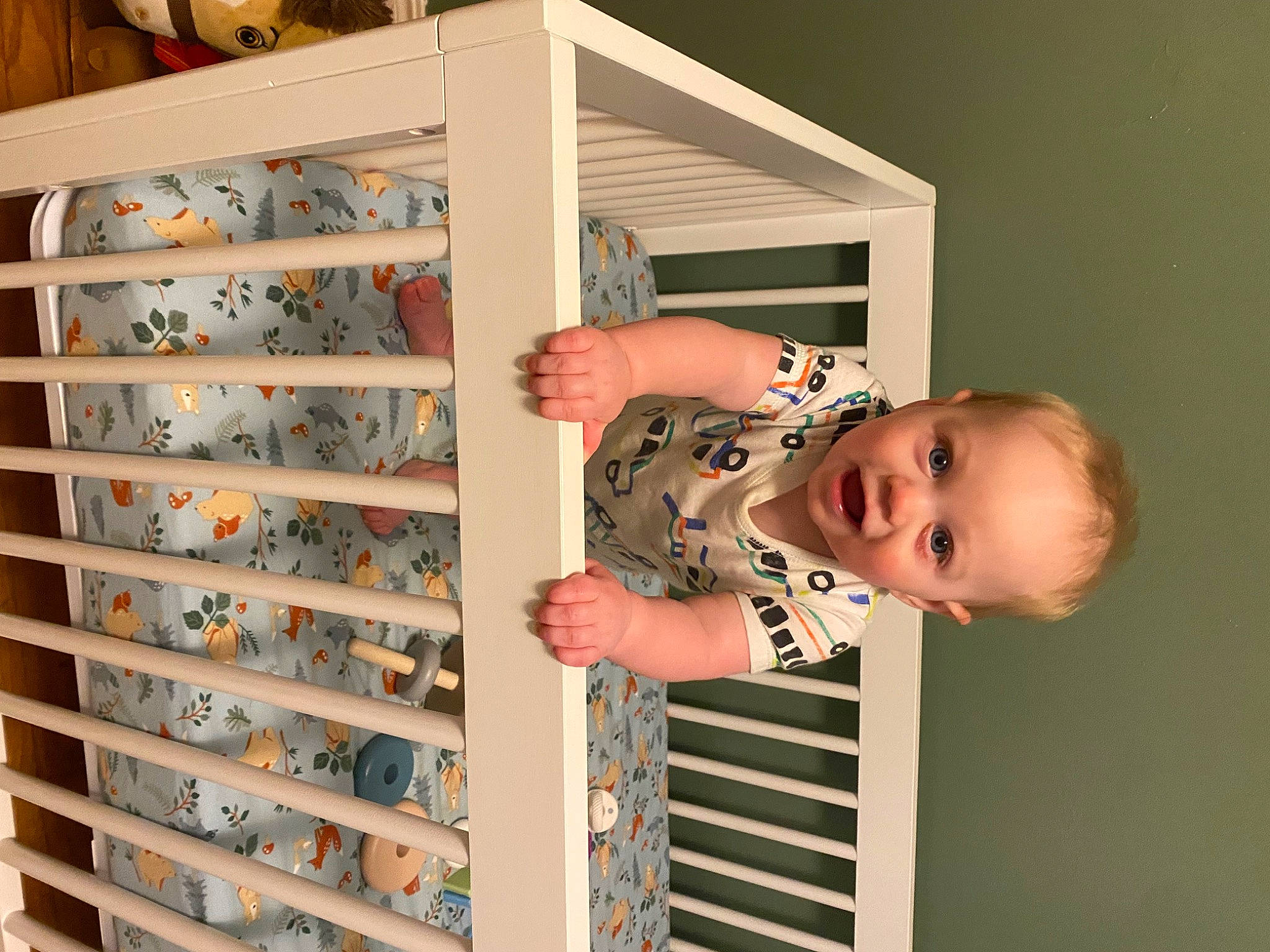 August is registered to the contest to win money with this photo: baby, baby_products, baby_toddler_clothing, engineering, finger, happy, machine, metal, pattern, person, room, shelf, shelving, sleeve, smile, toddler, wine_rack, wood, wrist