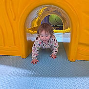 Amelianah is registered to the contest to win money with this photo: toddler, child, playground, yellow_tunnel, crawling, blue_floor, indoor_play_area, happy, smiling, playtime, fun, colorful, plastic, floor_texture, young_child, casual_clothing, curly_hair, active, exploring, daylight