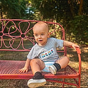 John joined the competition — help win amazing prizes! toddler, child, smiling, bench, outdoor, garden, sunlight, grass, sneakers, gray_tshirt, black_socks, metal_bench, playful, cute, summer, nature, portrait, happy, sitting, daylight