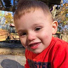 Jaxson is registered to the contest to win money with this photo: cheek, chin, cool, ear, eyelash, forehead, fun, grass, hairstyle, happy, head, jaw, joy, lip, mouth, nose, person, plant, smile, t_shirt