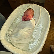 Lorene Hazel joined the competition — help win amazing prizes! newborn, baby, towel, bathtub, wrapped, sleeping, indoor, wooden_cabinet, floor, plastic_wrap, infant, resting, cozy, hospital, person, child, bedroom, quiet, soft_lighting, blanket