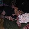 Lorene Hazel is registered to the contest to win money with this photo: baby, man, sleeping, couch, blanket, tattoo, bracelet, ring, black_shirt, green_pants, indoor, resting, holding, skin, peaceful, intimate, family, night, relaxing, comfort