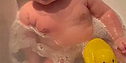 Conrad is registered to the contest to win money with this photo: baby, bathtub, bubbles, child, foam, fun, head, indoor, infant, person, play, rubber_duck, skin, smile, soap, toddler, water, wet, yellow, young