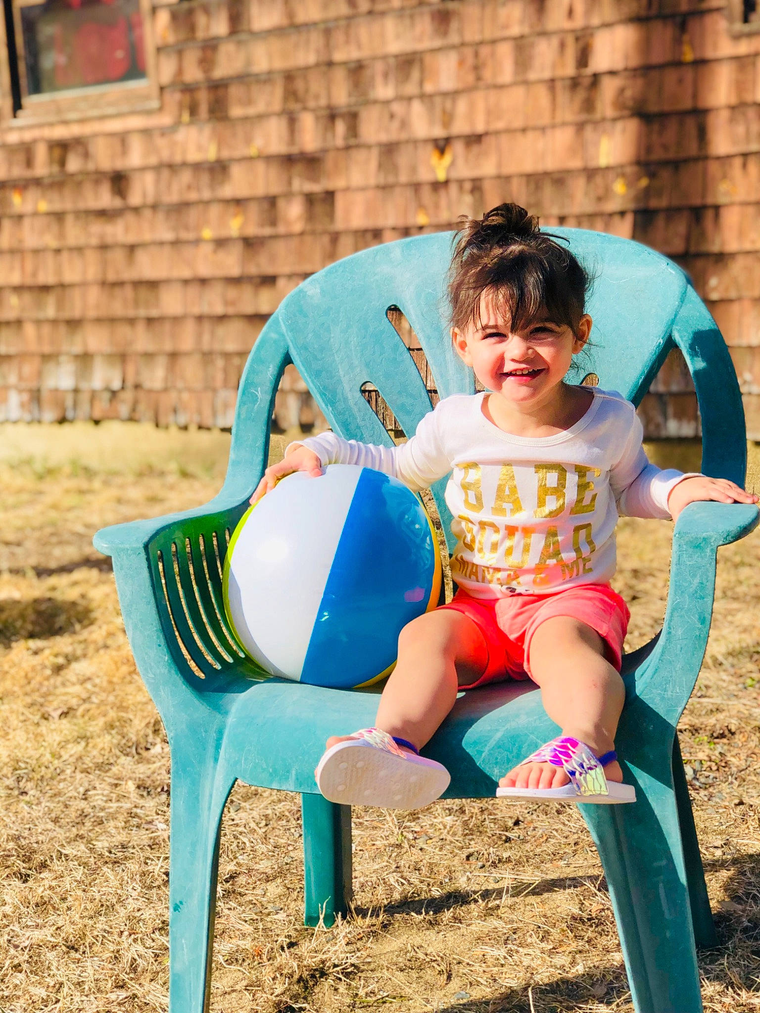 Kaitlynn is registered to the contest to win money with this photo: chair, child, fun, furniture, human_settlement, joy, outdoor_play_equipment, person, play, playground, public_space, recreation, sitting, smile, summer, toddler, turquoise, vacation