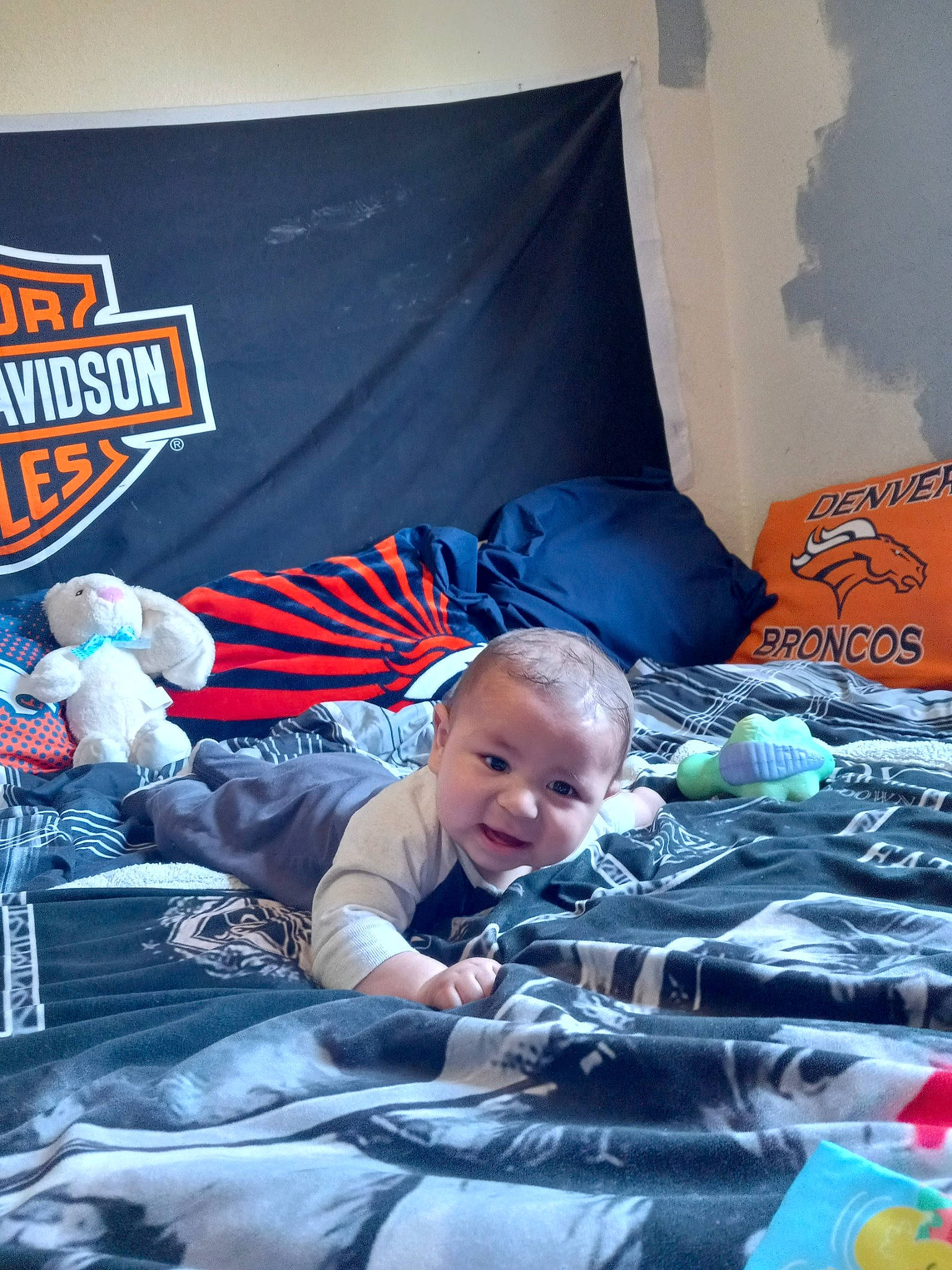 Brandon is registered to the contest to win money with this photo: automotive_design, baby, bedding, child, comfort, electric_blue, event, flag_of_the_united_states, fun, leisure, linens, motor_vehicle, person, plastic, play, recreation, room, sitting, t_shirt, textile