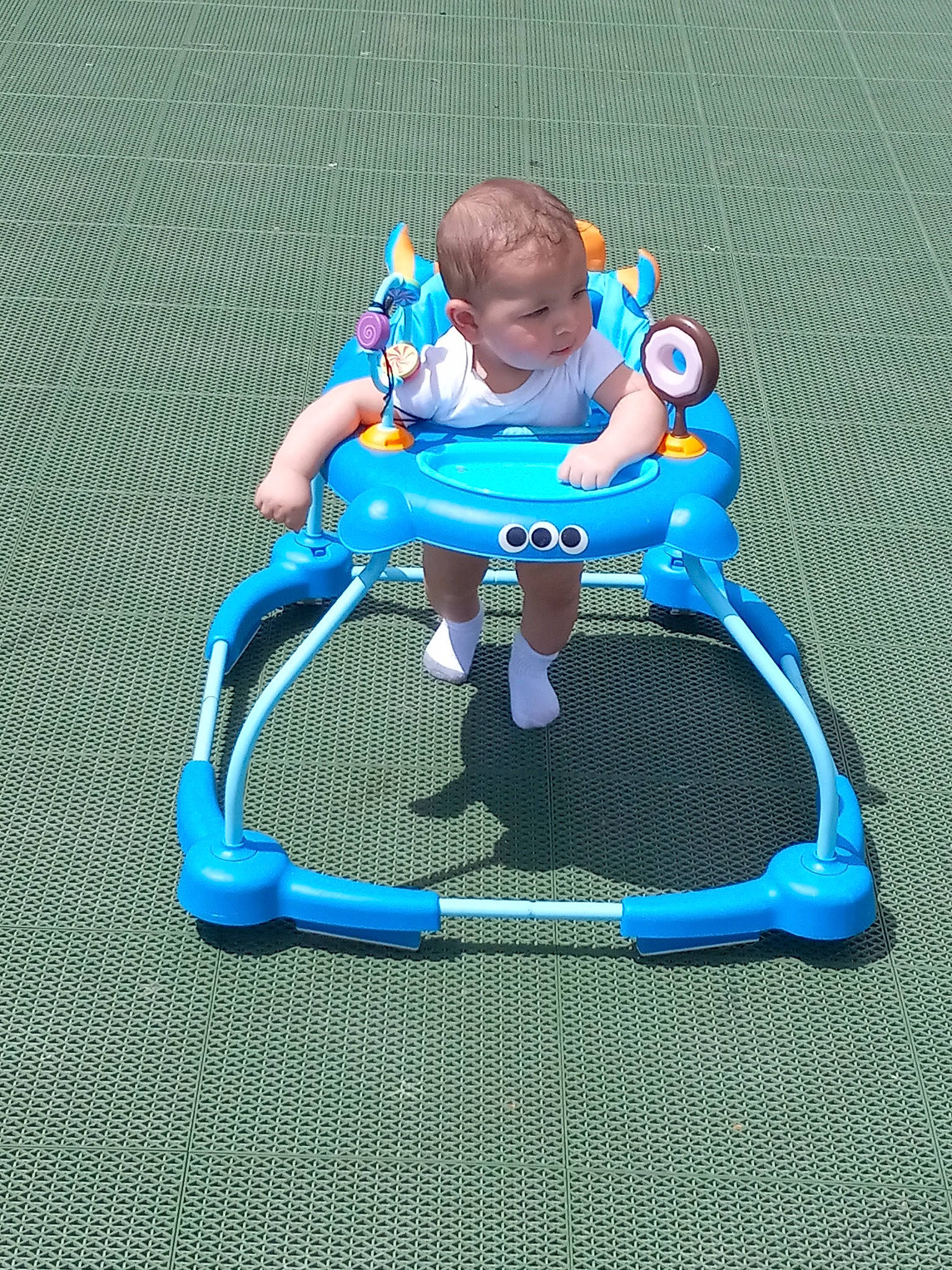 Brandon is registered to the contest to win money with this photo: baby, baby_products, baby_toddler_clothing, baby_toys, child, comfort, electric_blue, fictional_character, fun, grass, knee, leisure, person, plastic, play, playing_sports, recreation, riding_toy, sitting, toddler