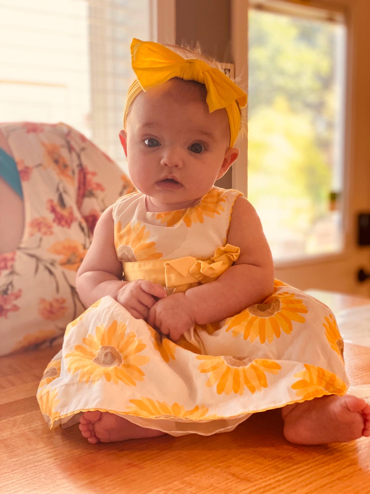 Bonnie is registered to the contest to win money with this photo: baby, baby_toddler_clothing, child, comfort, costume, day_dress, dress, fashion_accessory, fun, happy, headband, human_leg, jewellery, orange, peach, person, pink, ruffle, sitting, toddler