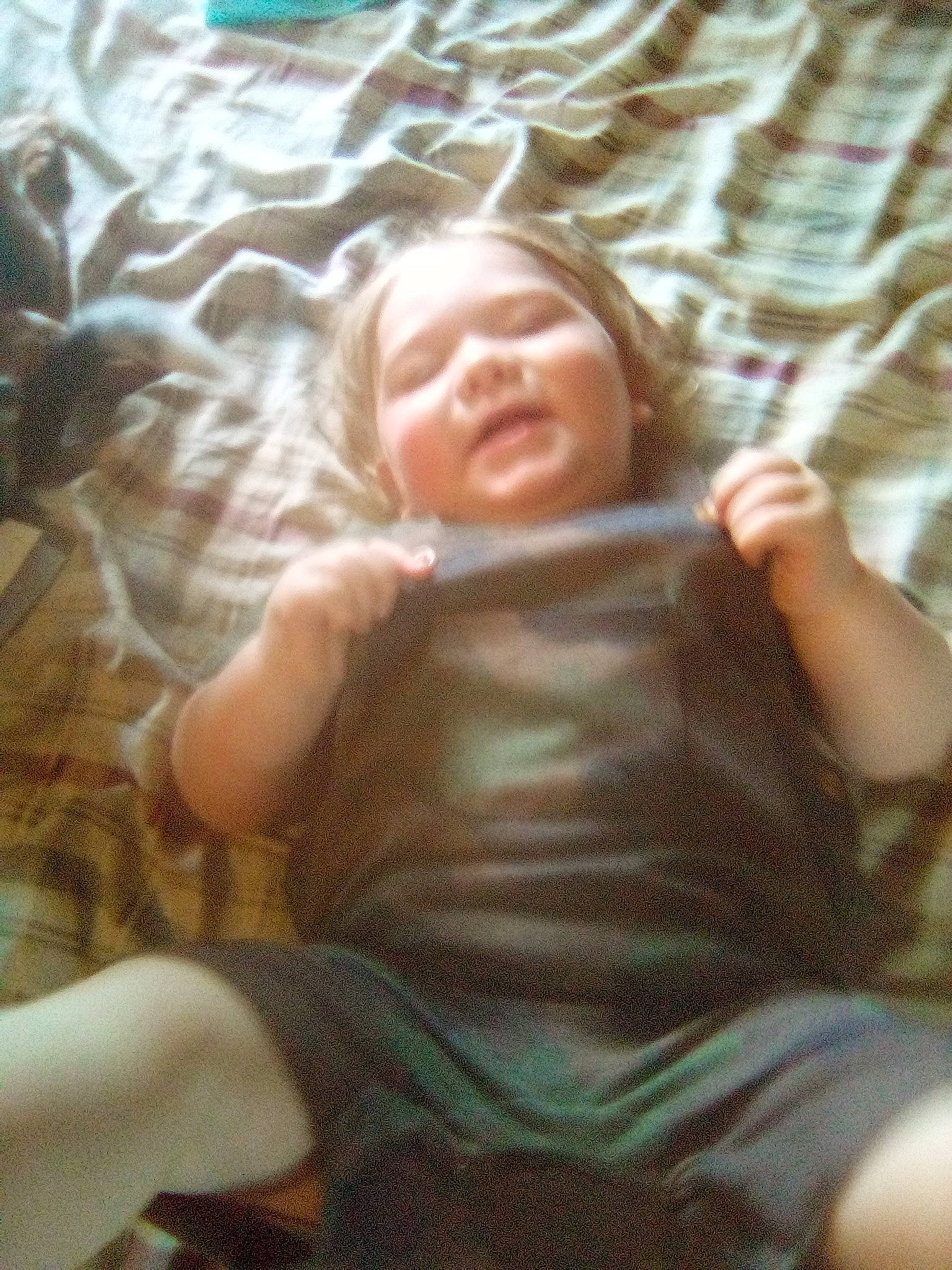 Johnathon is registered to the contest to win money with this photo: baby, baby_toddler_clothing, cheek, child, comfort, eye, finger, flooring, fun, grass, hair, human_body, mammal, muscle, person, sitting, skin, textile, thumb, toddler