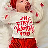baby, infant, red_bow, pacifier, white_blanket, valentines_day, red_pants, cute, festive, headband, tulle_sleeves, lying_down, holiday_outfit, soft_texture, adorable, child, young, celebration, heart_design, portrait