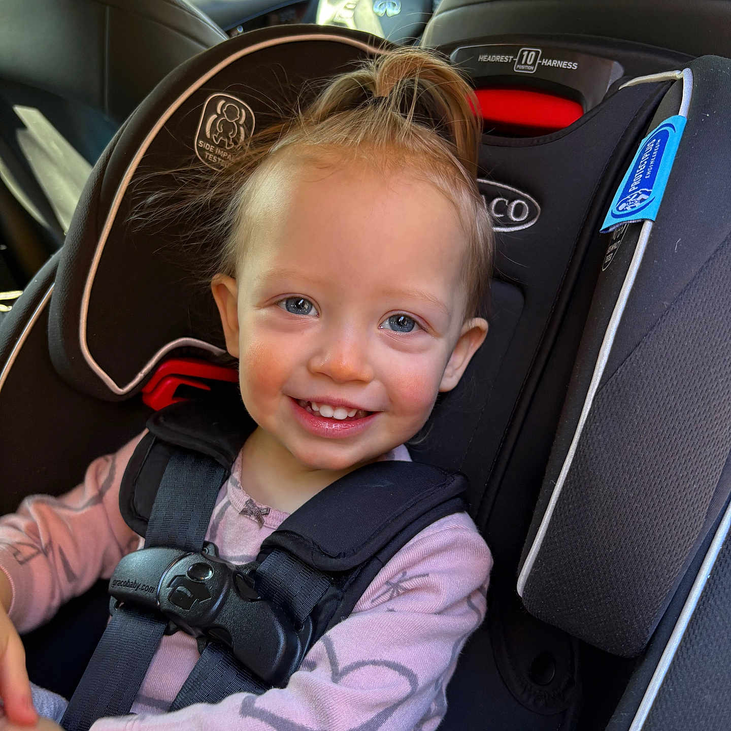 Lianna is registered to the contest to win money with this photo: accessories, alloywheel, baby, belt, car, car_interior, carseat, carwheel, cushion, face, head, homedecor, machine, person, photography, portrait, spoke, tire, transportation, vehicle