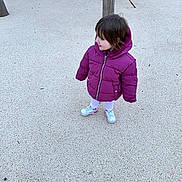 Marianna participe au concours pour gagner de l'argent avec cette photo : child, purple_jacket, playground, outdoor, sneakers, young_child, curly_hair, standing, play_equipment, winter_clothing, concrete_surface, casual_wear, person, daylight, cute, smile, small_child, cold_weather, fun, park