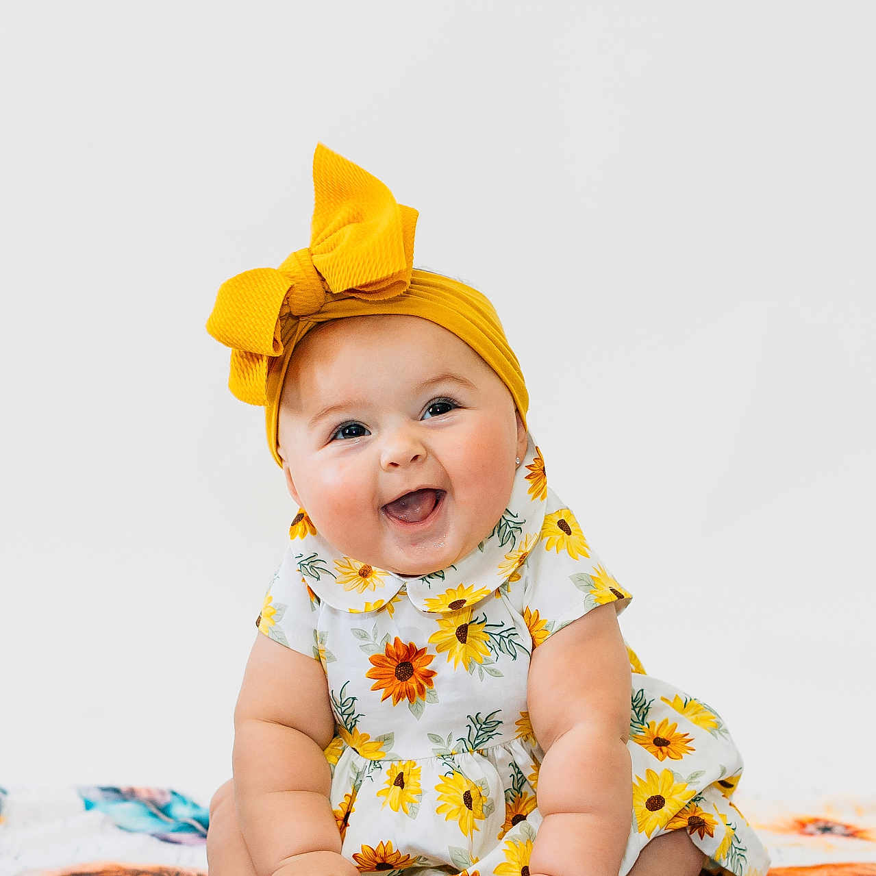 Freya joined the competition — help win amazing prizes! baby, babylaughing, bodypart, bonnet, cap, clothing, crawling, dress, face, finger, hand, happy, hat, head, laughing, person, photography, portrait, sitting, smile