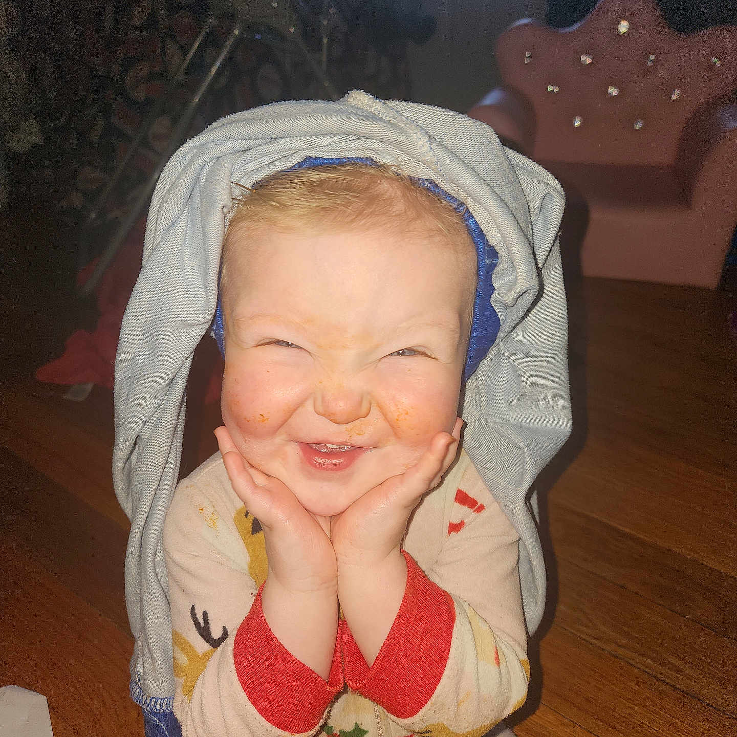 Pammy is registered to the contest to win money with this photo: baby, bonnet, clothing, coat, face, furniture, happy, hardwood, hat, head, hood, hoodie, knitwear, person, photography, portrait, smile, sweater, sweatshirt, wood