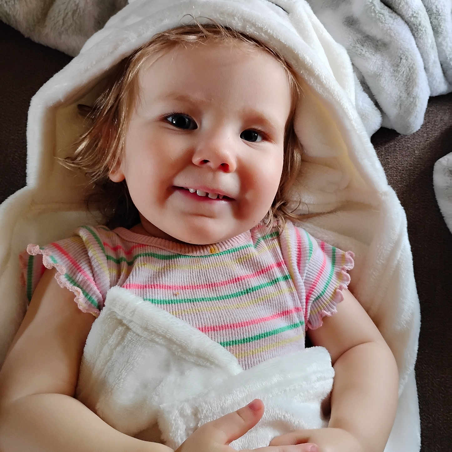 Gabriella joined the competition — help win amazing prizes! baby, blanket, bodypart, bonnet, clothing, face, finger, hand, happy, hat, head, hood, hoodie, knitwear, newborn, person, photography, portrait, smile, towel