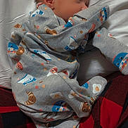 Atreus is registered to the contest to win money with this photo: baby, sleeping, onesie, grey_clothing, pillow, plaid, red, black, face, head, infant, cute, cozy, patterned_clothing, soft, resting, child, comfort, indoor, person