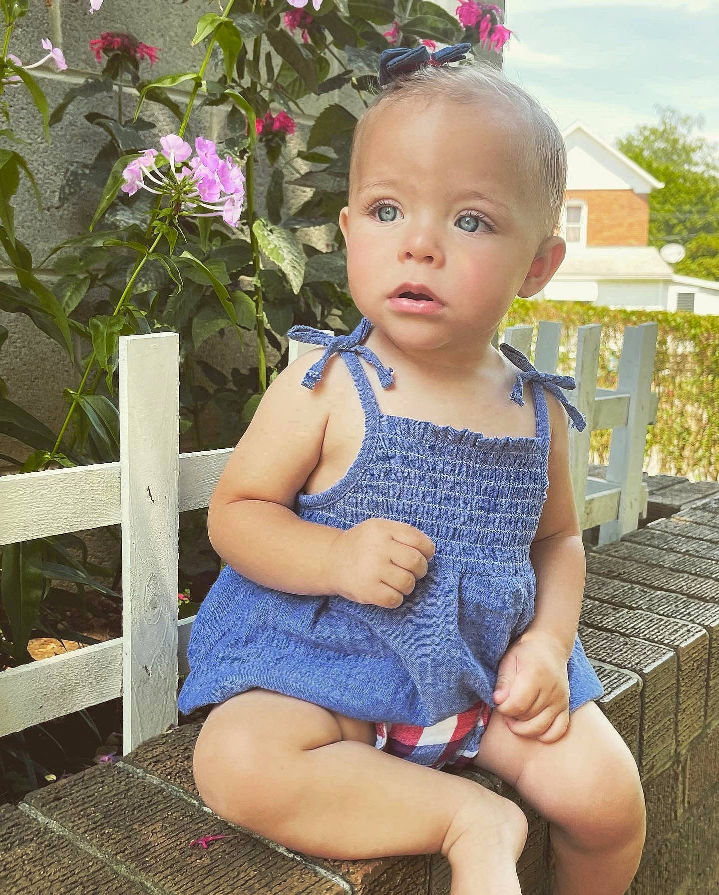 Juliana is registered to the contest to win money with this photo: baby_toddler_clothing, dress, electric_blue, eye, face, flower, grass, hair, happy, head, human_body, iris, leaf, lip, person, pink, plant, skin, standing, thigh