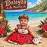 Daleyza Everly joined the competition — help win amazing prizes! baby, infant, child, sitting, smiling, portrait, flower_crown, red_dress, tropical, beach, sand, ocean, palm_trees, hibiscus, wooden_sign, stuffed_animal, cow_toy, seashells, outdoor, colorful
