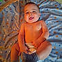 Julius joined the competition — help win amazing prizes! baby, infant, diaper, sock, striped_sock, smiling, happy, playful, blanket, stars, blue_blanket, indoor, child, cute, lying_down, person, skin, head, face, hands