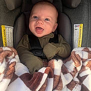 Jaxson joined the competition — help win amazing prizes! baby, car_seat, blanket, pacifier, smiling, child, happy, infant, seatbelt, clothing, fabric, head, face, person, indoor, closeup, cute, warm, comfort, soft