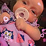 baby, pacifier, infant, cute, cartoon_clothing, pink, hearts, sparkles, closeup, child, adorable, portrait, soft_lighting, indoor, person, clothing, hand, face, young_child, sleepwear