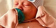 Ayda Grace is registered to the contest to win money with this photo: newborn, baby, sleeping, pacifier, hat, bow, mittens, blanket, pink, striped, cozy, closeup, indoors, infant, cute, soft, peaceful, child, portrait, resting
