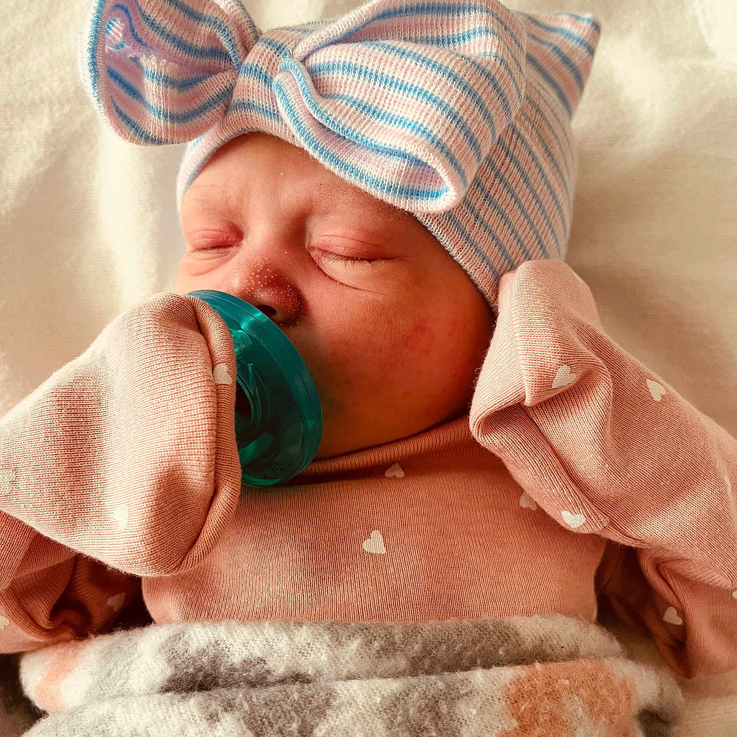 Ayda Grace is registered to the contest to win money with this photo: baby, blanket, bow, child, closeup, cozy, cute, hat, indoors, infant, mittens, newborn, pacifier, peaceful, pink, portrait, resting, sleeping, soft, striped