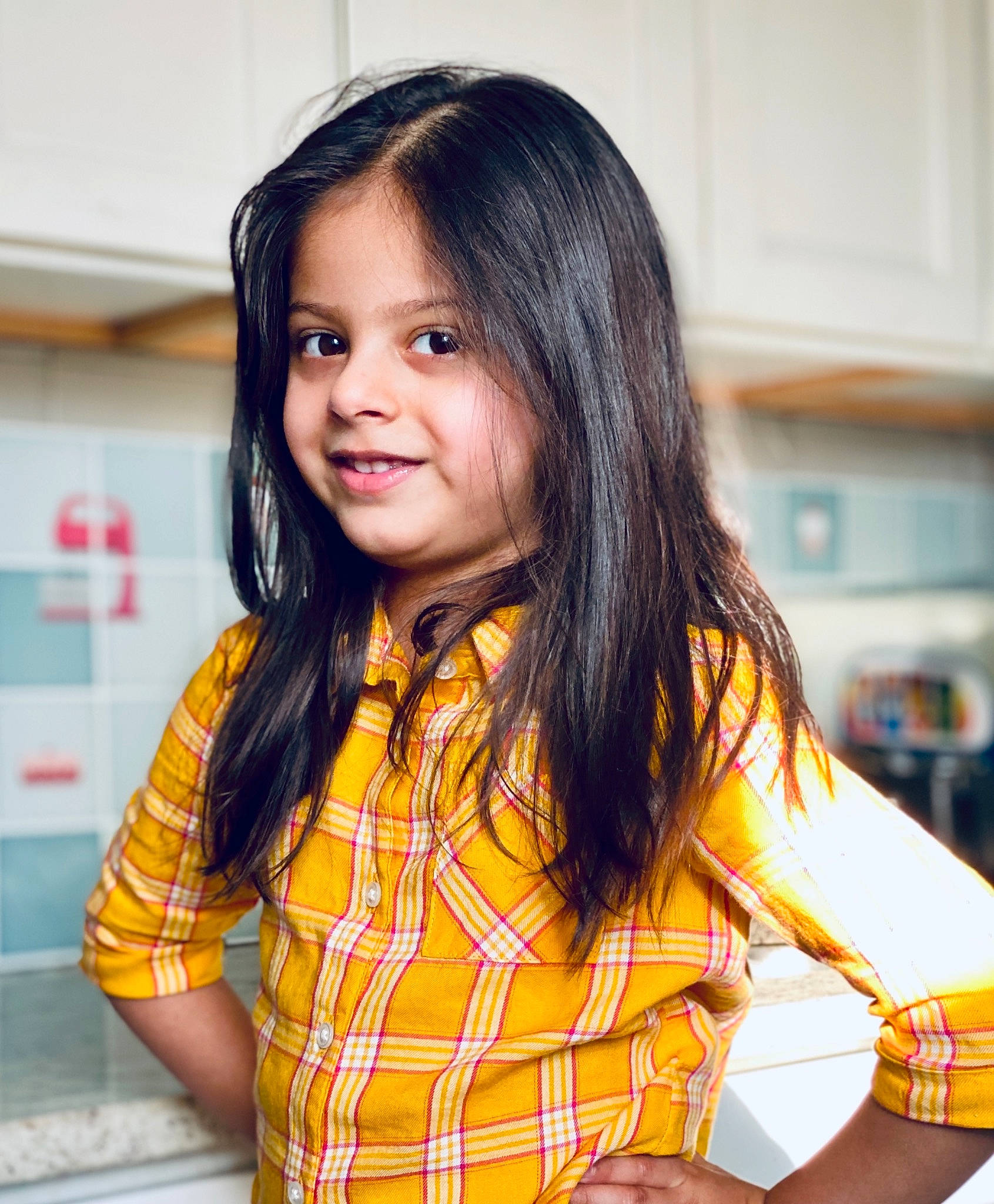 Ishna Brahme is registered to the contest to win money with this photo: beauty, bracelet, child, elbow, fun, happy, jewellery, joy, necklace, pattern, person, plaid, portrait_photography, room, sitting, skin, sleeve, smile, t_shirt, tartan