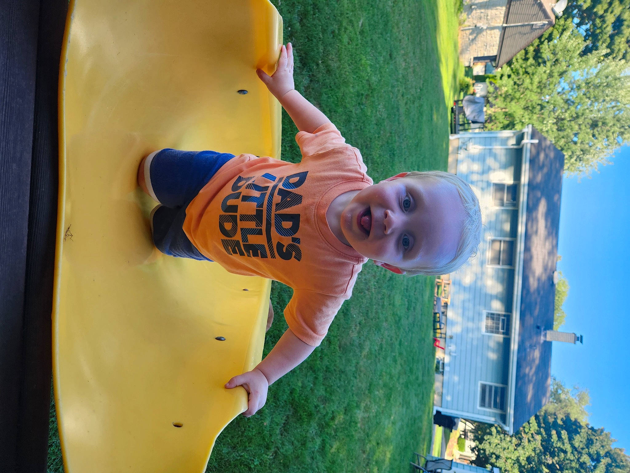 Chase is registered to the contest to win money with this photo: blue, child, city, fun, grass, happy, human_leg, leisure, outdoor_play_equipment, person, photograph, plant, play, recreation, sky, smile, snapshot, summer, t_shirt, toddler