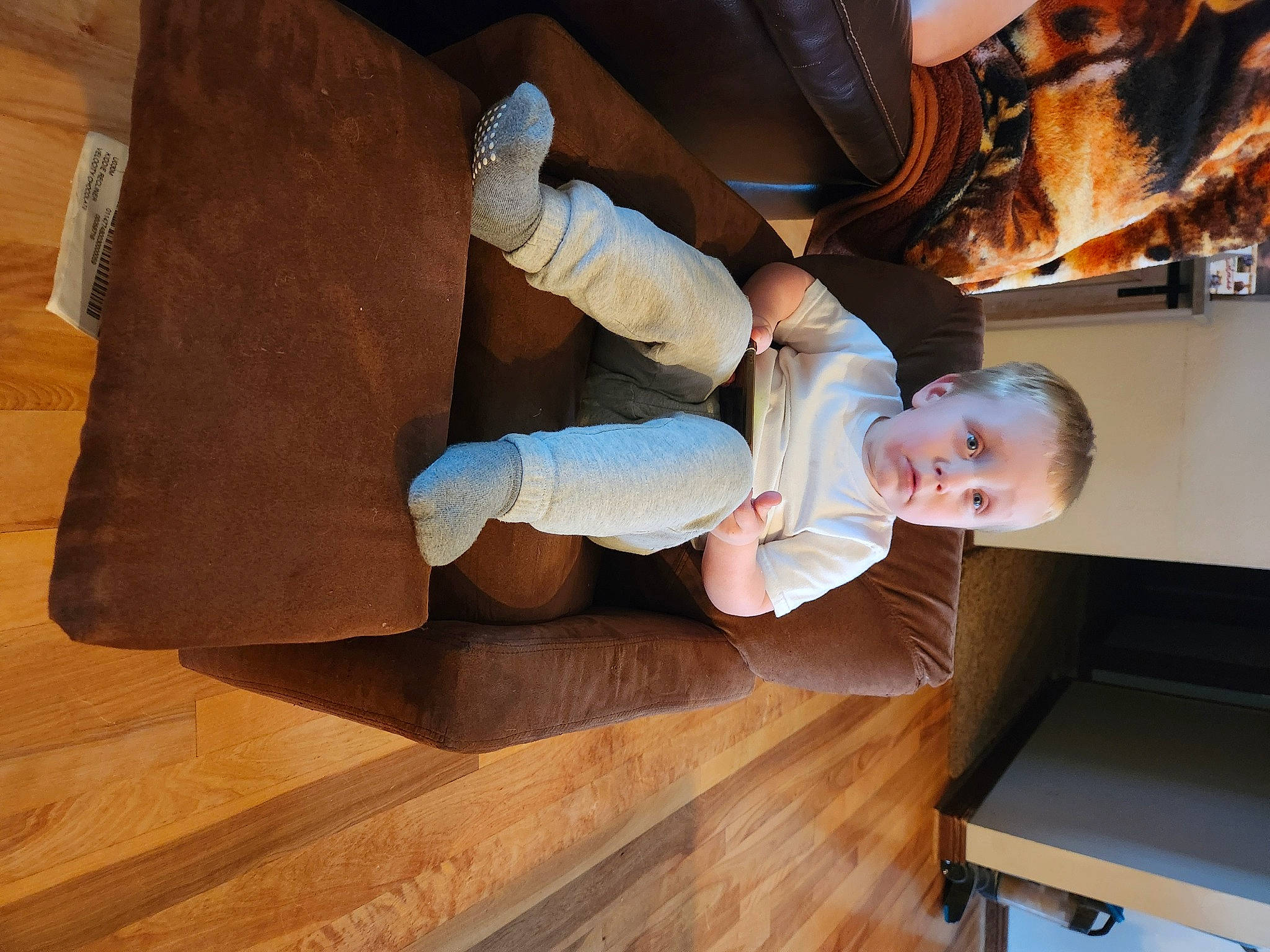 Chase is registered to the contest to win money with this photo: baby, baby_toddler_clothing, child, comfort, drawer, finger, floor, flooring, foot, gesture, hardwood, human_leg, laminate_flooring, person, plank, surprise, thumb, toddler, varnish, wood