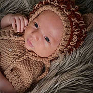 Santino is registered to the contest to win money with this photo: baby, infant, knitwear, bonnet, cozy, blanket, fur, portrait, cute, child, soft, warm, hand, face, skin, laying, indoors, newborn, fashion, closeup