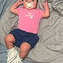Ava joined the competition — help win amazing prizes! baby, infant, pacifier, pink_shirt, blue_shorts, white_sneakers, blanket, bed, carpet, feet, person, child, indoor, cute, lying_down, headband, clothing, footwear, sleepwear, comfort