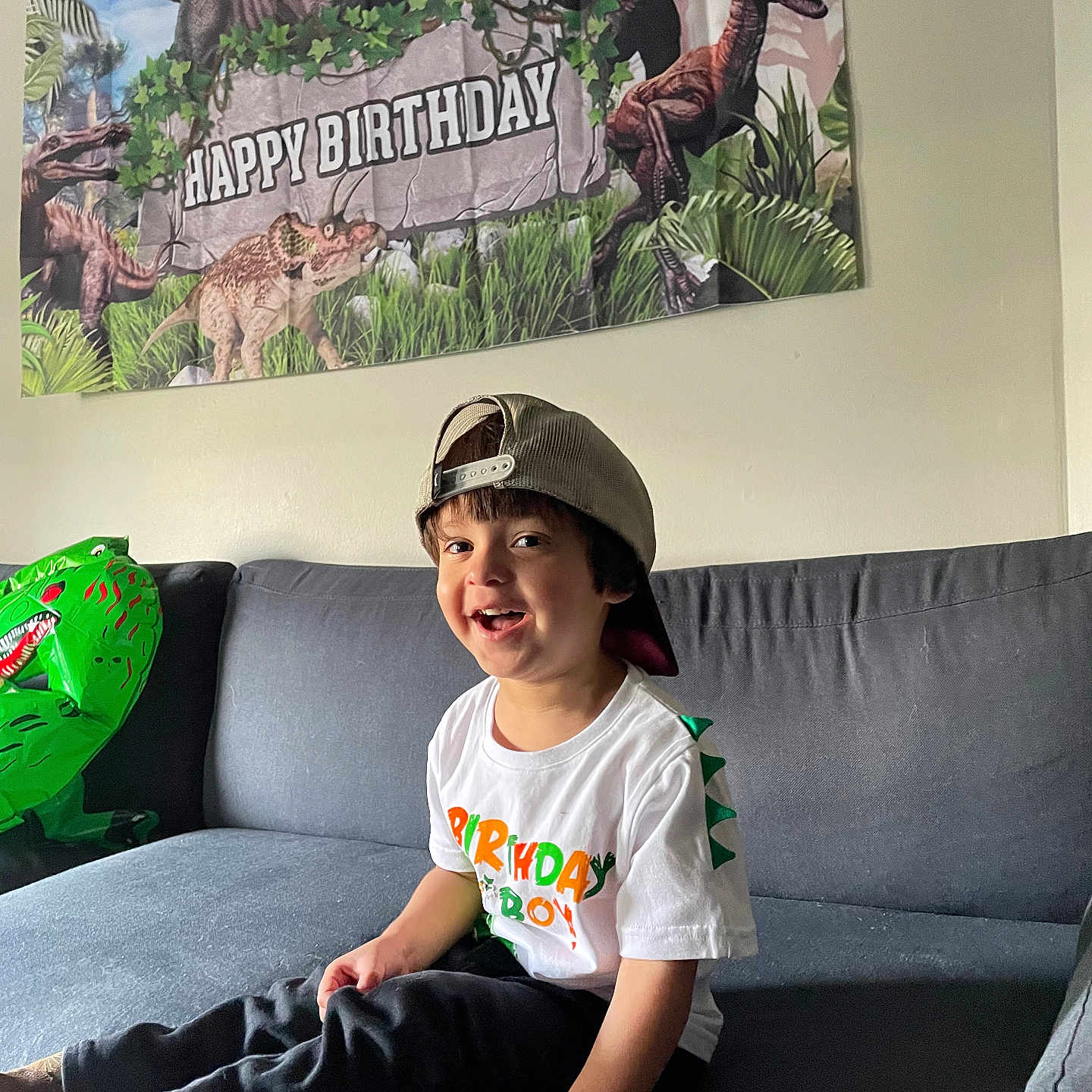 Branson joined the competition — help win amazing prizes! animal, architecture, boy, building, child, clothing, couch, dinosaur, face, furniture, head, indoors, male, pants, person, photography, portrait, reptile, sitting, t_shirt