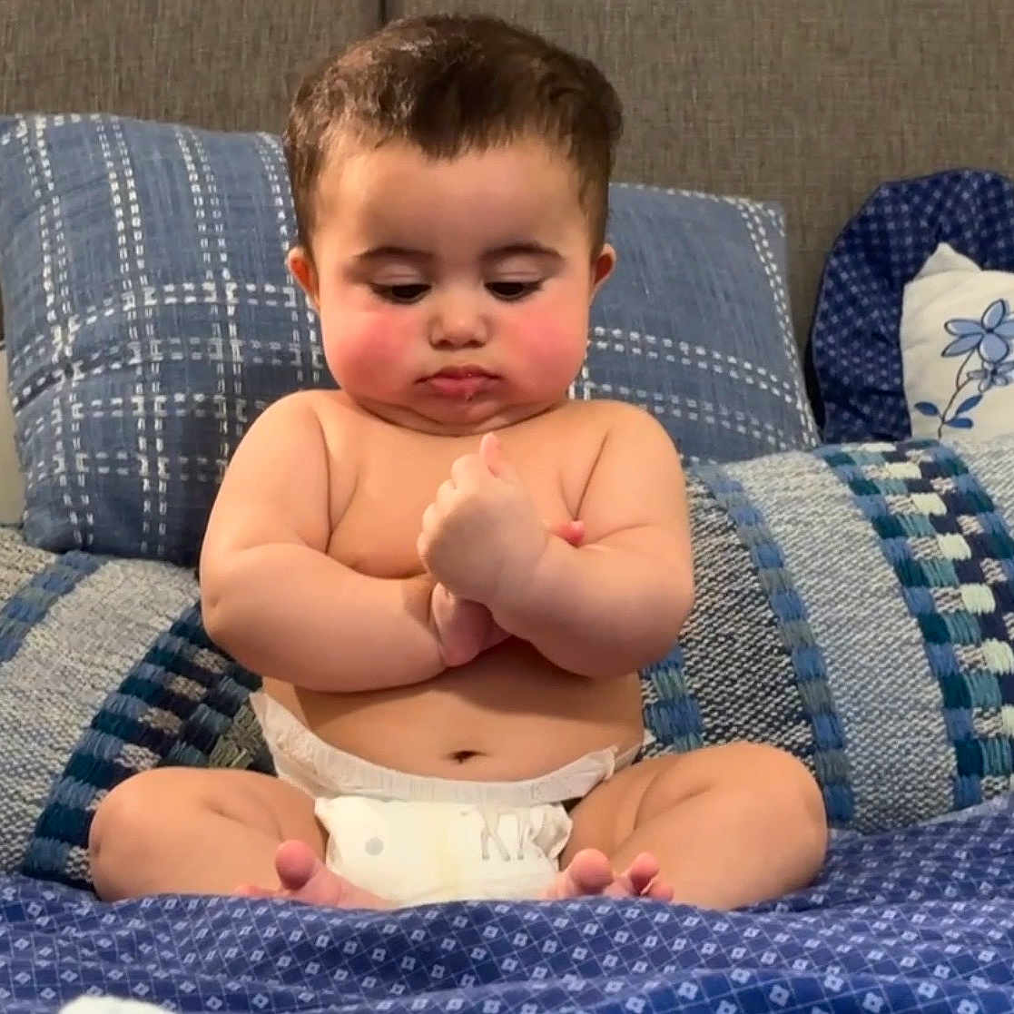 Isa joined the competition — help win amazing prizes! baby, bed, bedding, blanket, blue_bedding, chubby_cheeks, couch, cute, diaper, eyes, face, fingers, hands, indoor, infant, patterned_textile, pillow, portrait, sitting, toes