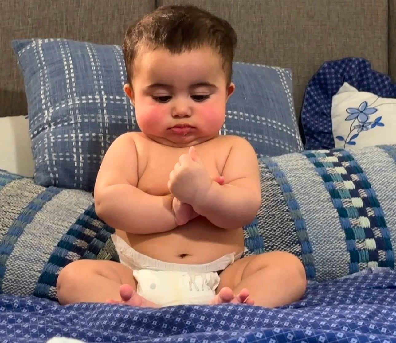 Isa joined the competition — help win amazing prizes! baby, infant, diaper, pillow, blanket, bed, sitting, chubby_cheeks, face, eyes, hands, fingers, toes, indoor, bedding, couch, patterned_textile, blue_bedding, cute, portrait