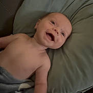 James joined the competition — help win amazing prizes! baby, smiling, pillow, blanket, couch, infant, happy, face, skin, arm, head, lying_down, indoor, comfort, child, young, expression, relaxation, soft, cozy