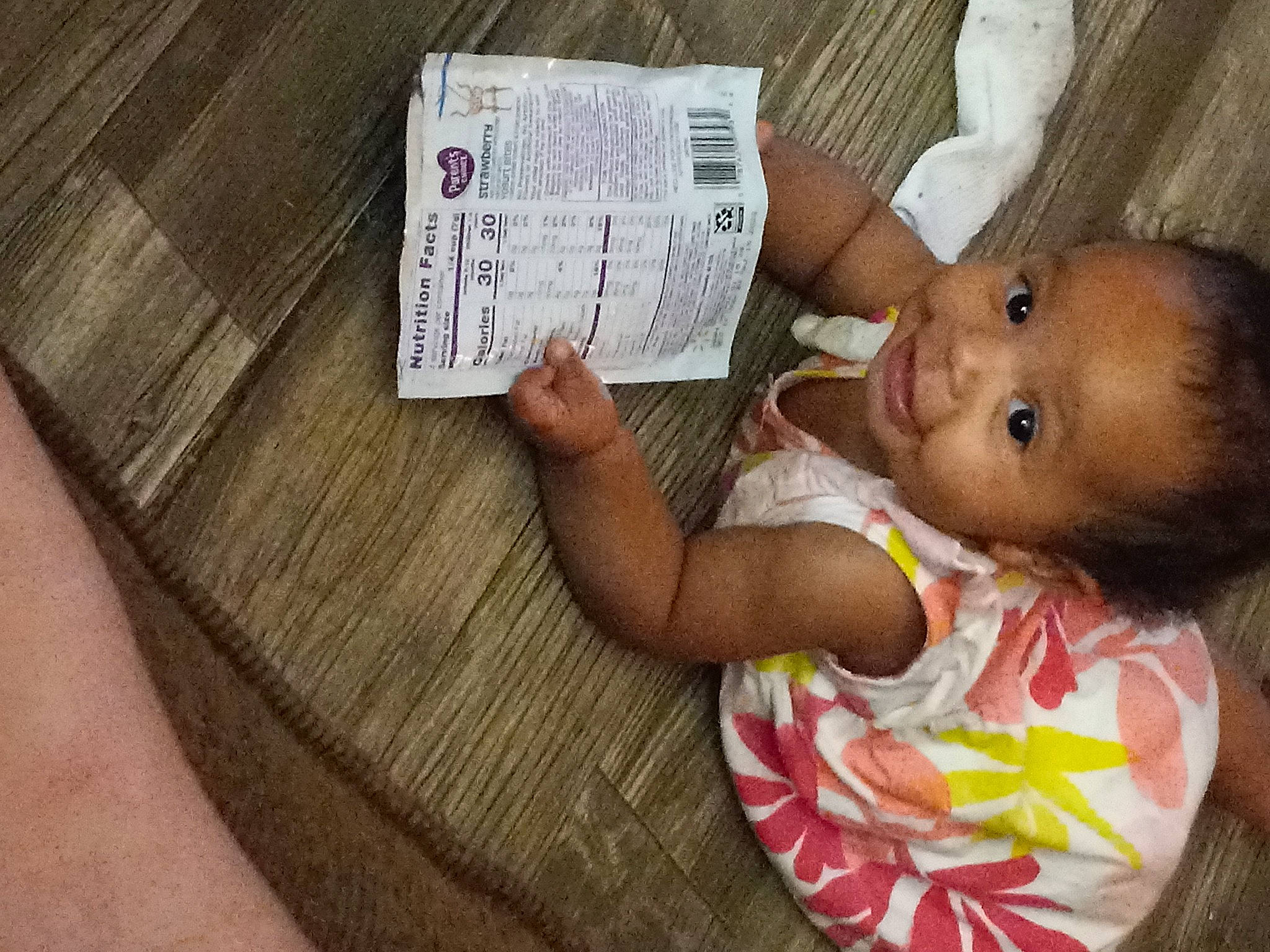 Genesis is registered to the contest to win money with this photo: arm, baby, baby_products, baby_toddler_clothing, cheek, child, finger, flooring, fun, happy, hardwood, nail, nose, person, room, skin, smile, thumb, toddler, tree