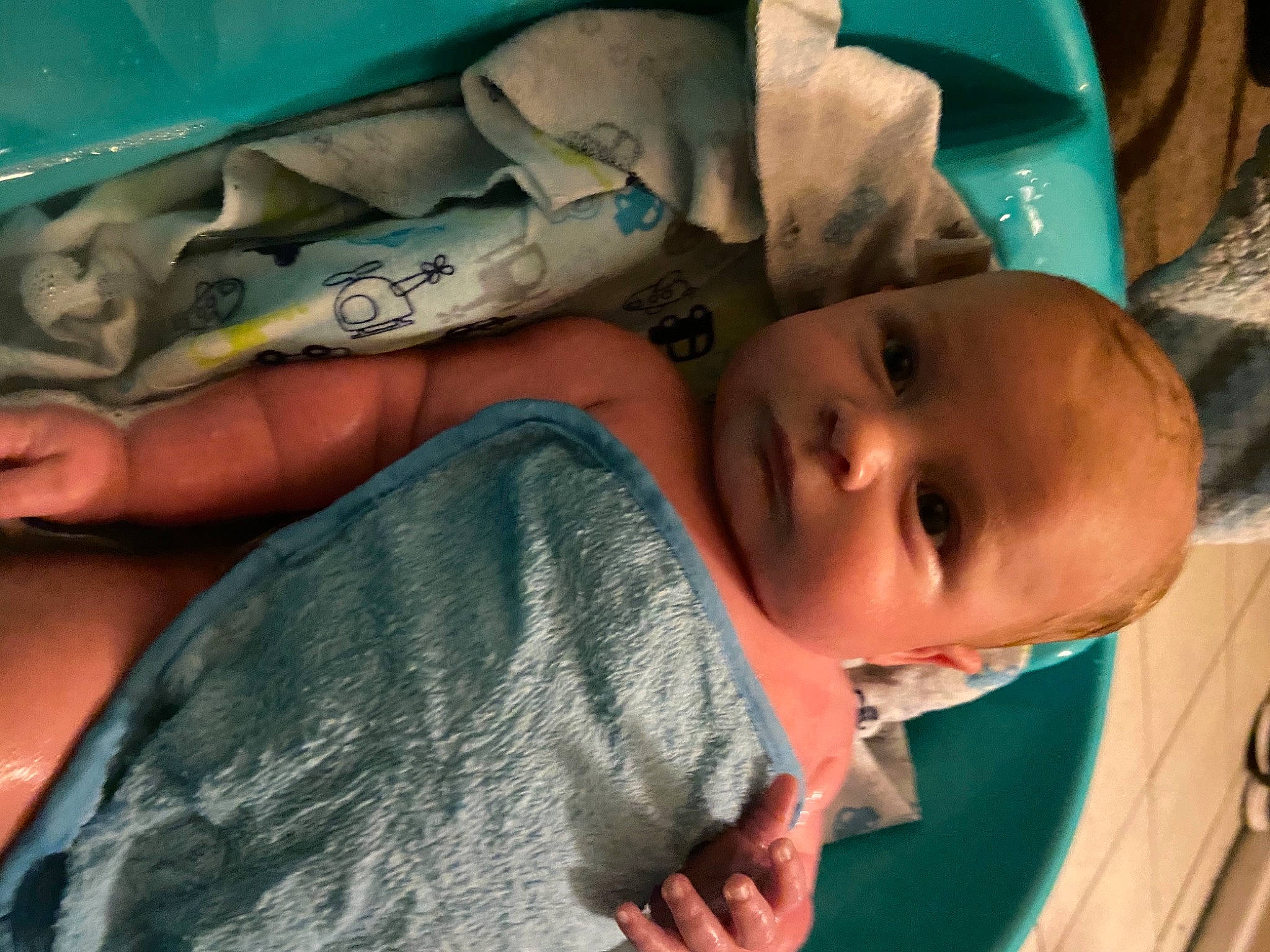 Westley is registered to the contest to win money with this photo: azure, baby, baby_products, cheek, child, comfort, facial_expression, finger, fun, happy, linens, mouth, nose, person, room, skin, smile, textile, toddler, tree