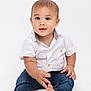 baby, toddler, child, barefoot, white_shirt, blue_jeans, sitting, curious, cute, portrait, studio, isolated, hands, feet, smiling, innocent, young, fashion, casual, front_view