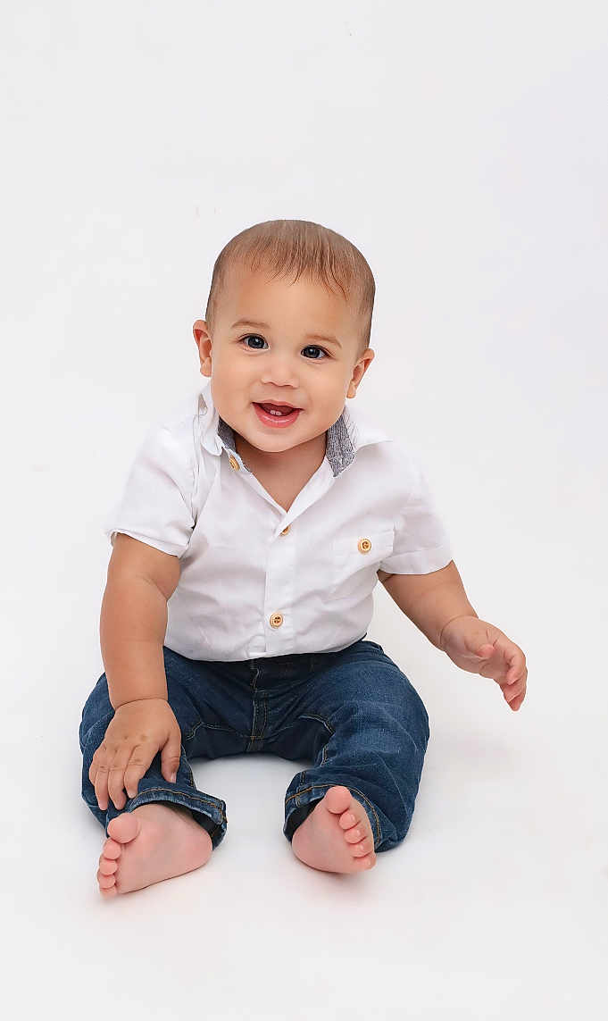 Elisha Garcia Rivera joined the competition — help win amazing prizes! baby, barefoot, blue_jeans, bright_background, casual_clothing, child, cute, expression, front_view, happy, infant, innocence, isolated, one_person, portrait, sitting, smiling, studio, white_shirt, young_child