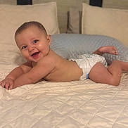 Ryder joined the competition — help win amazing prizes! baby, diaper, smiling, bed, quilted_bedspread, pillow, indoor, infant, skin, happy, child, cute, resting, lying_down, cheeks, head, person, young, room, comfort