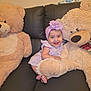 Cataleya joined the competition — help win amazing prizes! baby, child, teddy_bear, stuffed_animal, couch, smiling, happy, headband, flower, purple, plush, indoor, person, sitting, cute, toy, furniture, leather, infant, playful