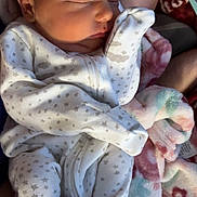 Amelia joined the competition — help win amazing prizes! newborn, baby, sleeping, onesie, star_pattern, blanket, soft, cozy, infant, cute, peaceful, child, clothing, fabric, portrait, resting, human, toddler, bedtime, comfort