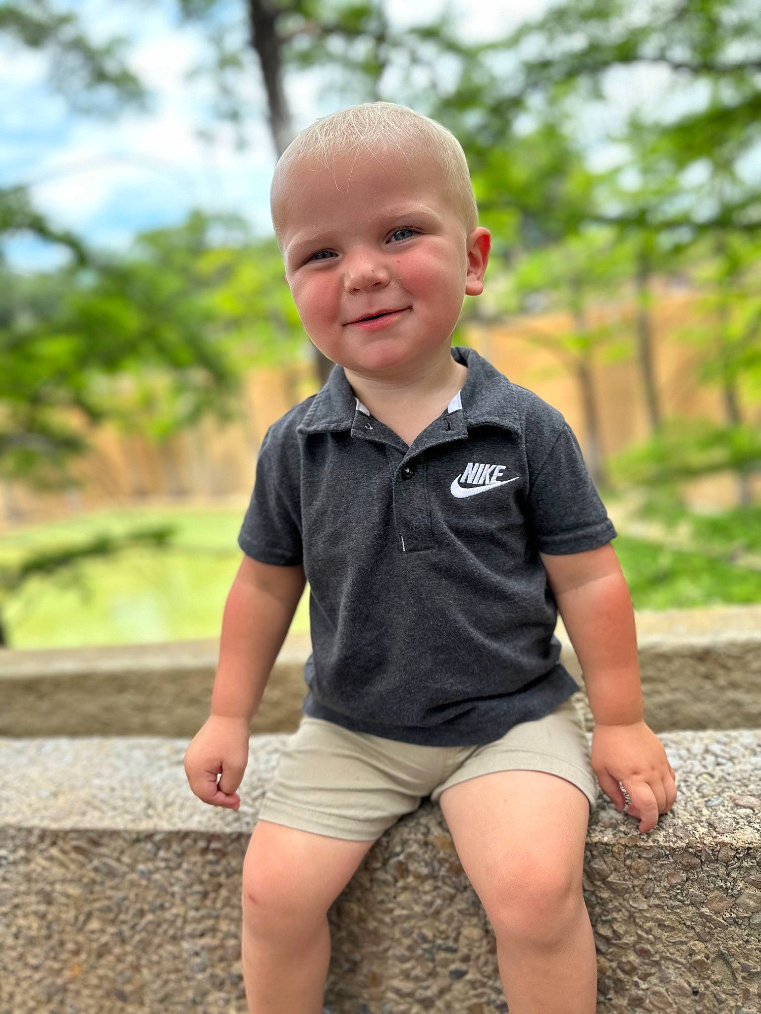 Gavin is registered to the contest to win money with this photo: baby_toddler_clothing, eye, face, flash_photography, fun, grass, happy, head, joy, leisure, people_in_nature, person, plant, shorts, skin, sky, sleeve, smile, t_shirt, thigh