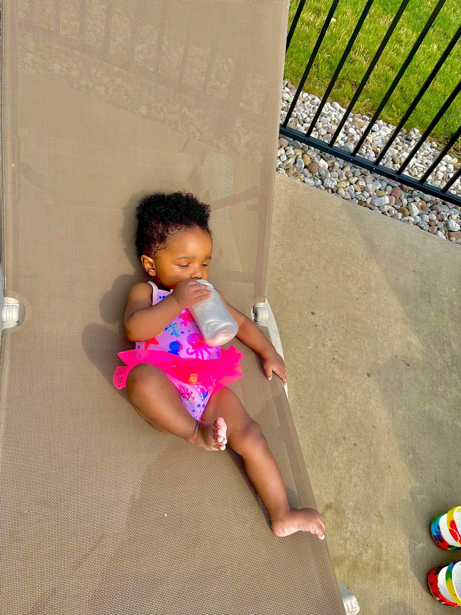 Anyla is registered to the contest to win money with this photo: baby, baby_toddler_clothing, barefoot, child, flooring, foot, fun, head, human_body, human_leg, knee, leg, leisure, outdoor_furniture, person, play, sandal, sitting, skin, thigh