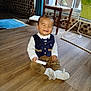 Haroun a rejoint le concours — aidez-le/la à gagner de superbes lots ! baby, child, smiling, sitting, indoor, wooden_floor, vest, pants, sock, toy, chair, high_chair, curtain, window, plant, home, floor, person, cute, happy